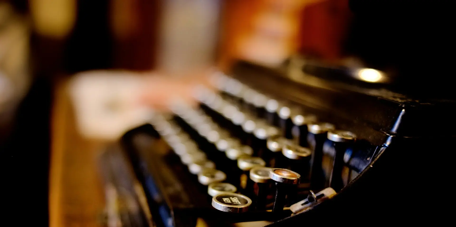 black and white typewriter on brown wooden table